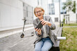 © Miljan Živković - Mature woman use mobile smart phone play video games sit outdoor