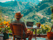 © Focalfinder - A man teleworking at a wooden table, surrounded by a serene landscape. with green mountains