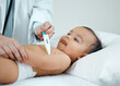 © KayJoint/peopleimages.com - Doctor, hands and baby with thermometer for checkup, exam and test for healthcare on bed in clinic. Woman or pediatrician, fever and infant or newborn for medical consultation and results in hospital