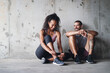© peopleimages.com - Couple, sneakers and tie lace outdoor for fitness, wellness and accountability as relationship goals. Man, woman and workout by bridge with teamwork, exercise and cardio together for body health