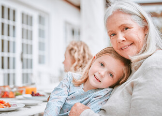 Poster - Family, lunch and portrait of girl with grandmother for love, support and holiday celebration. Happy, child and relax with hug of woman by food for meal nutrition, thanksgiving and care at home