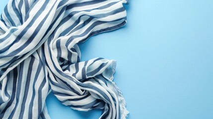 Wall Mural - striped cotton scarf on blue background top view with space for text