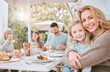 © DavisShared/peopleimages.com - Hug, woman and big family with happiness in backyard for celebration, lunch or bonding together. Grandparents, children and generations with embrace on patio for party, gathering or love at home
