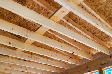 Wall Mural - Building new home involves framing roofing trusses with wooden frame beams