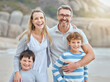 © peopleimages.com - Portrait, beach and family with love, hug and vacation with getaway trip, Bali and tropical island. Face, parents and mother with father, boys or kids with holiday, childhood and seaside with embrace