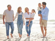 © MagicDavid/peopleimages.com - Walking, family and happy on beach for adventure, connection and together by ocean or sea. Water, people or grandparents with children for love, freedom and travel for vacation in summer or Miami