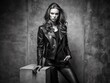 © Man888 - Luxurious black and white portrait of empty space where fashion model once stood, showcasing haute couture leather jacket and outfit on elegant stone pedestal backdrop.