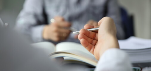 Wall Mural - Hand of businessman in suit filling and signing with silver pen partnership agreement form clipped to pad closeup. Management training course some important document, team leader ambition concept