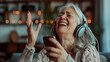 © Dentma Art - Senior woman enjoying music with headphones and phone