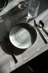 Poster - A simple table setting with plate, fork, spoon, and glass