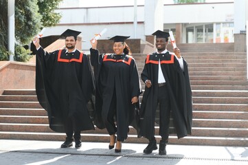 Wall Mural - Diverse international students with diplomas at university campus