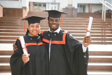 Wall Mural - Group of multiracial graduate students with diplomas on university background