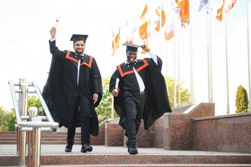 Wall Mural - Two friends are university graduates. Indian and African graduates