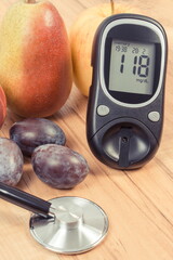 Glucose meter with sugar level and fresh fruits. Healthy lifestyle and nutrition during diabetes