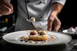 © AlfredoGiordano - close up horizontal image of a pastry chef finishing to plate a fancy dessert dish in a fine dining restaurant