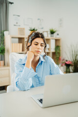 Wall Mural - One young beautiful caucasian business woman working in office on laptop and looking through charts