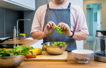 Chef at the kitchen preparing spicy glass noodle salad