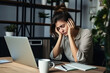 © July P - A woman puts her hands to her face from fatigue while sitting at a computer.