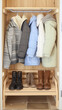 © aciddreamStudio - detail of interior cloakroom with coats and boots for autumn time and winter