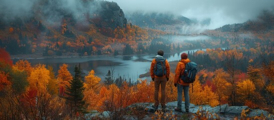 Wall Mural - Two Hikers Admire the Autumnal Landscape