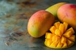 © nutcha - Close-up of ripe mangoes with a sliced mango on a rustic background, showcasing vibrant colors and fresh tropical fruit appeal.