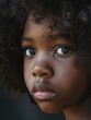 © Alexander Chaykin - A close-up shot of a young girl with curly hair, smiling at the camera