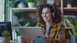© Maksym - Smiling businesswoman with headphones and a tablet, seated at her desk. Utilizing online internet technology for a video call or virtual meeting, female entrepreneur