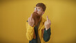 © Krakenimages.com - Handsome redhead bearded man in glasses showing middle fingers against a vibrant yellow background, projecting attitude.