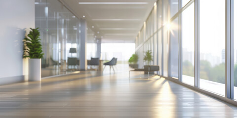 Wall Mural - Blurred background of a bright office hallway with large windows, potted plants. The light creates a warm and inviting atmosphere