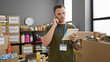 © Krakenimages.com - Handsome man with beard talking on phone and holding notebook in warehouse