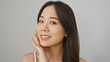 © Krakenimages.com - A beautiful young asian woman with a gentle smile poses against a white background, conveying freshness and simplicity.