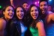 © Introvertia - Group of young adults smiling and taking selfie at vibrant party