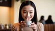 © Sathitchai - Asian woman drink a cup of coffee