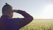 © procinemastock - Close up portrait of smiling man standing in green wheat field on sunset and looking at the camera - slow motion