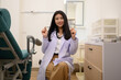 © eakarat - Smart attractive female doctor sitting in examination room Smiling and looking at the camera Trust health care workers in the hospital concept