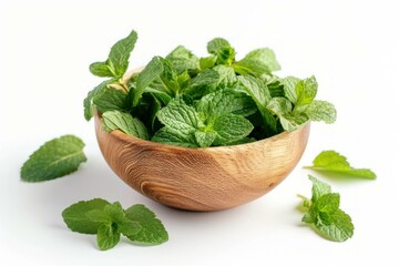 Wall Mural - Lush green mint leaves in a natural wooden bowl isolated on a white background