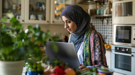 Wall Mural - Young Arabic female entrepreneur working from home in her kitche