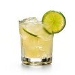 © Leli - A glass of yellow beverage with ice and lime garnish on a white background