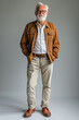 © TANAT - 13. Stylish senior man in a casual outfit, smiling happily, full body, High resolution photography, detailed, realistic, The photo is taken with a Canon EOS R5, with a 17mm, simple solid background,
