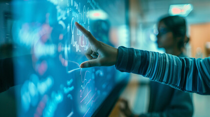 Wall Mural - close-up of an educator using a digital whiteboard in a classroom, focusing on their hand writing an