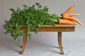 Canvas Print - Ripe carrots with lush green tops lying on an aged wooden table, perfect for healthy lifestyle themes