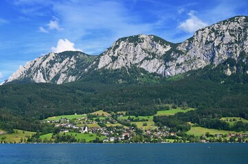 Attersee - a beautiful blue lake in Austria. Surrounded by mountains and green forests. Regions with nature in the Alps. A great place for sports, recreation and outdoor activity holidays.