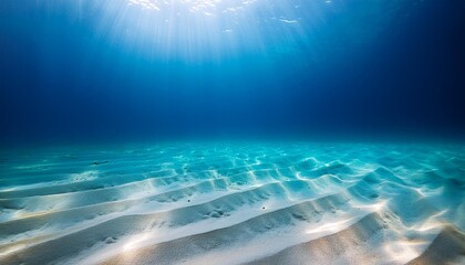 Wall Mural - abstract image of tropical sand beach on the bottom of underwater dark blue deep ocean wide nature background with rays of sunlight