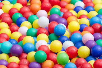 Hundreds of colorful plastic balls on kids playground.