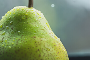 Wall Mural - A pear sits on a table with a white cloth.