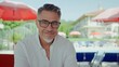 © nyul - Portrait of happy mature man smiling at luxury resort poolside