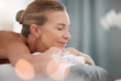 © Van Wyk/peopleimages.com - Spa treatment, peace or mature woman on bed for massage, physical therapy or luxury. Smile, eyes closed or female person in health resort for destress, rest or wellness in hotel for pamper or me time