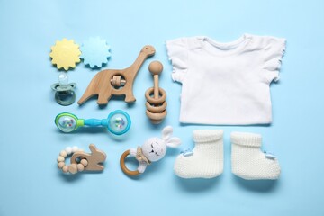 Wall Mural - Different baby accessories on light blue background, flat lay