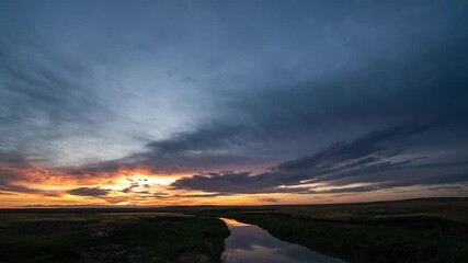 Wall Mural - beautiful colorful sunset over the river, red and yellow flashes. ripples on water surface of sea or