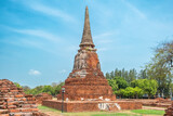 Ancient pagoda in Ayutthaya historical park Wat Mahathat temple, Thailand. Historical Buddhist stupa on archaelogical site under clear blue sky. Ancient architectural and cultural heritage